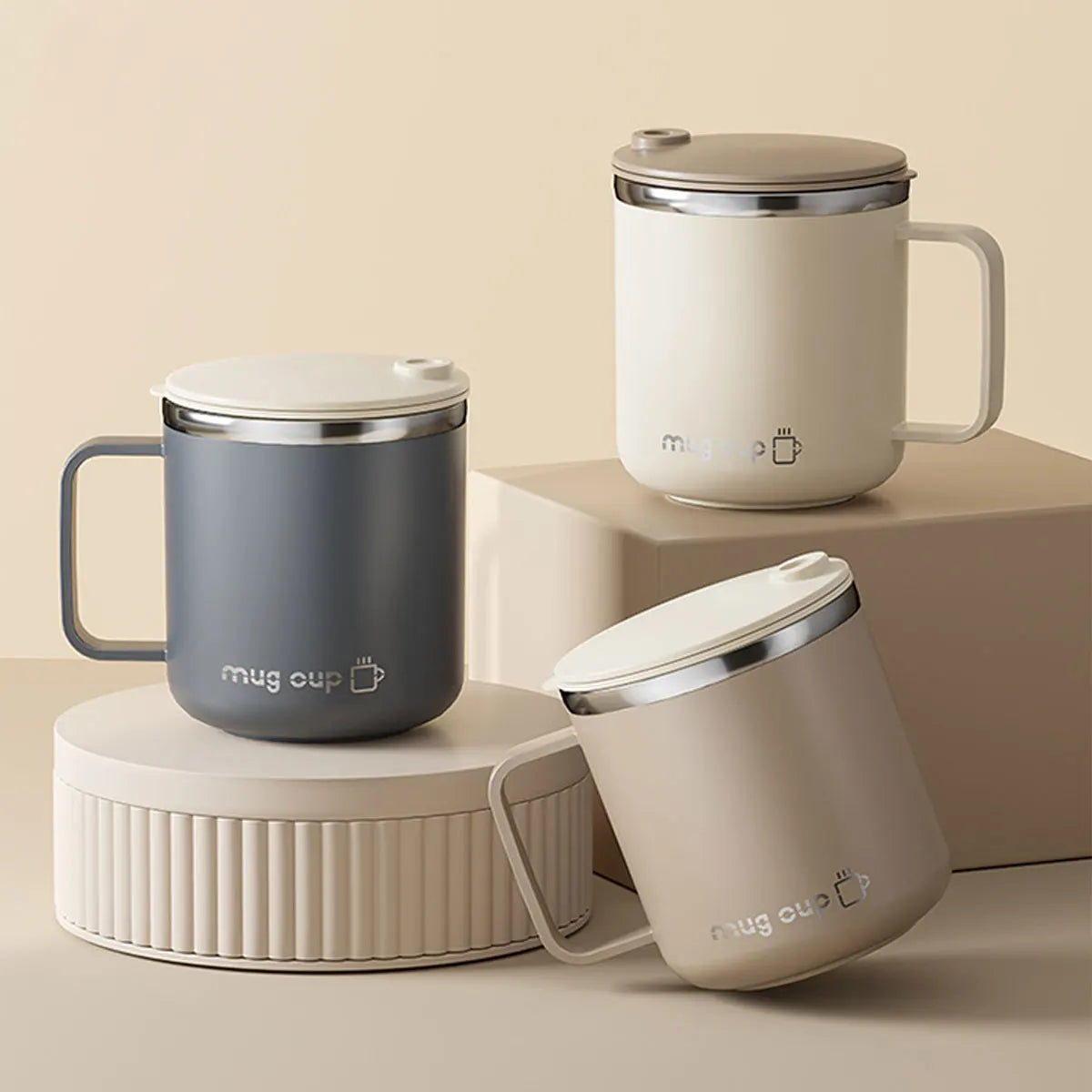 Three insulated mugs in gray, white, and beige on a beige background