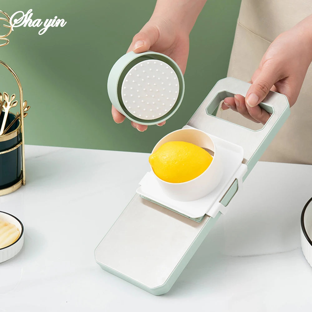 Person using a lemon squeezer on a white surface with a green background