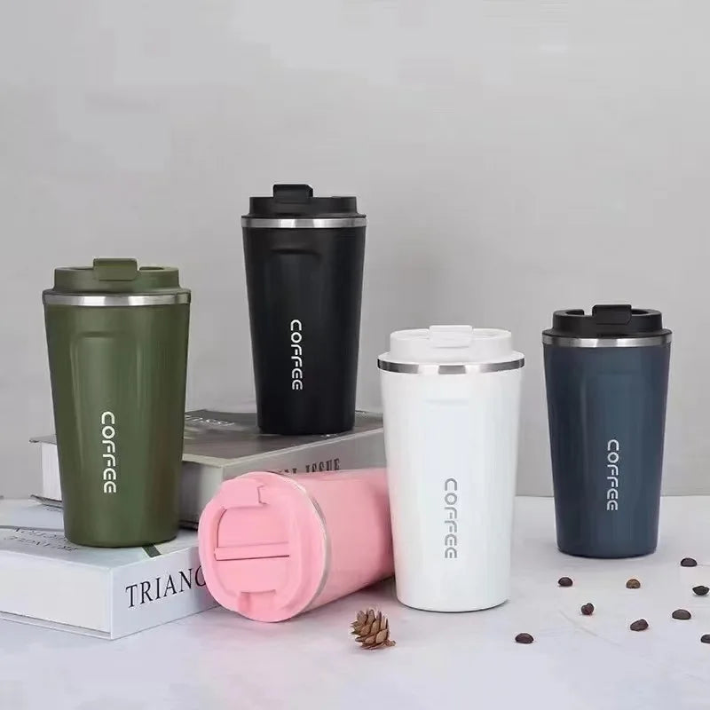 Set of colorful coffee tumblers with 'coffee' text on a neutral background