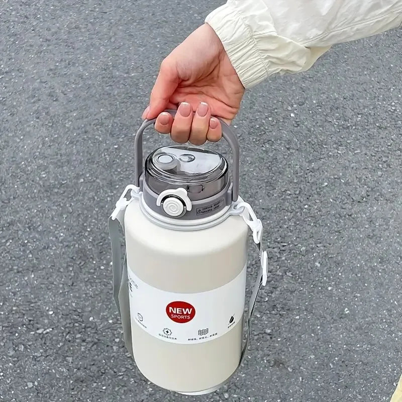 Hand holding a white thermos with a gray lid on a gray pavement background