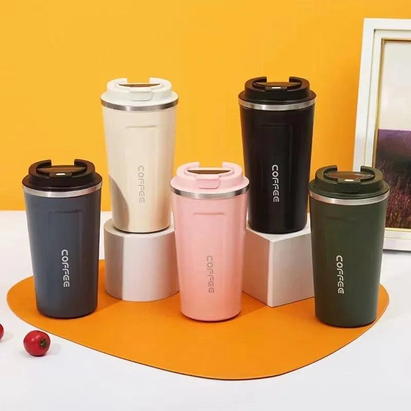 Set of colorful coffee tumblers with 'COFFEE' text on an orange background