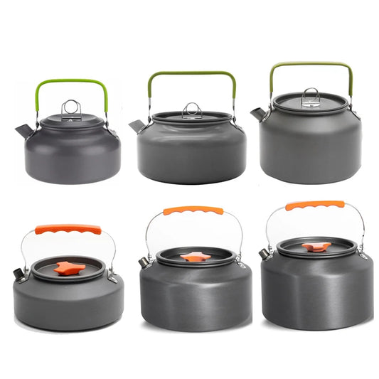 Set of six gray kettles with green and orange handles on a white background
