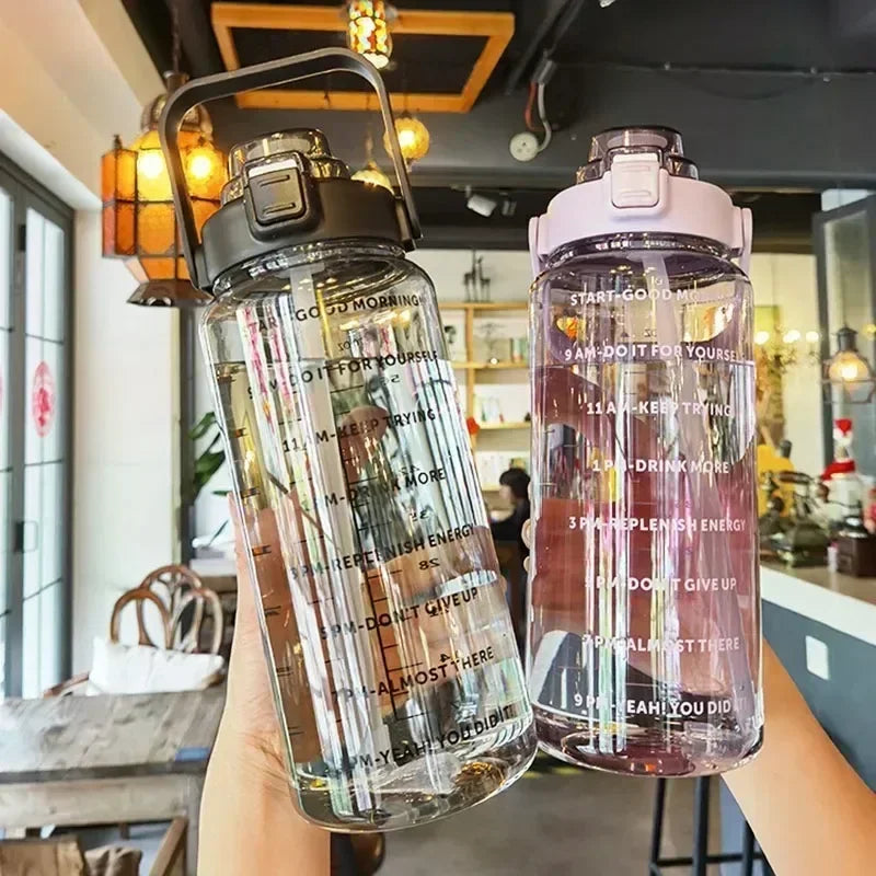 Two transparent water bottles with text designs held in a casual setting.