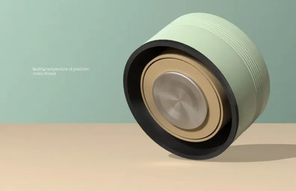 Close-up of a mechanical component on a beige surface with a light green background