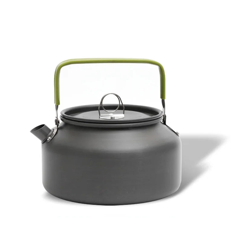 Black camping kettle with a green handle on a white background