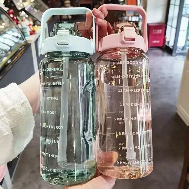 Two water bottles with text on them held by a person indoors.