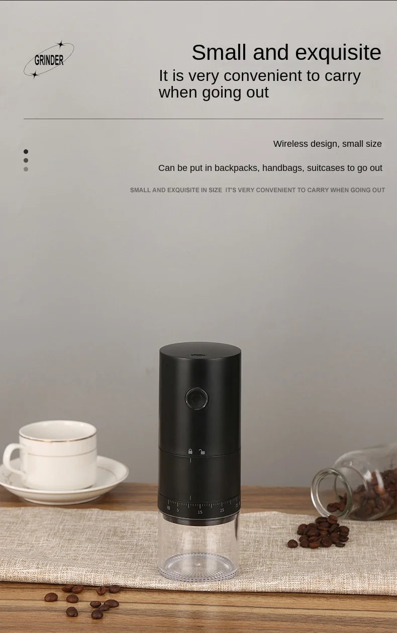Black coffee grinder on a wooden surface with coffee beans and a cup in the background.
