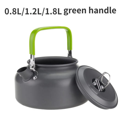 Gray kettle with a green handle on a white background
